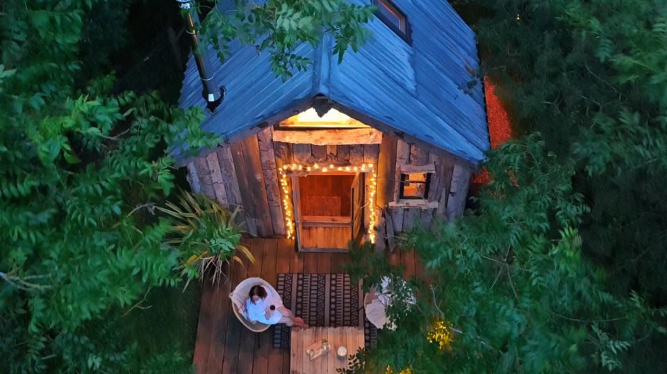 Tiny House lit up at dusk