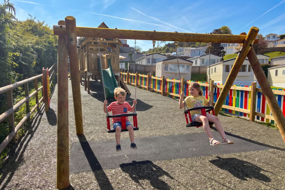 Play area with swings above the caravans