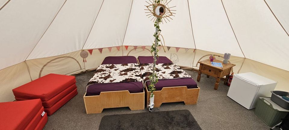 Inside the bell tent with two beds
