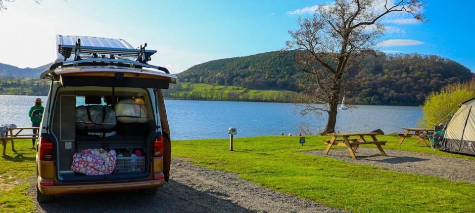 Campervan by the lake with picnic benches