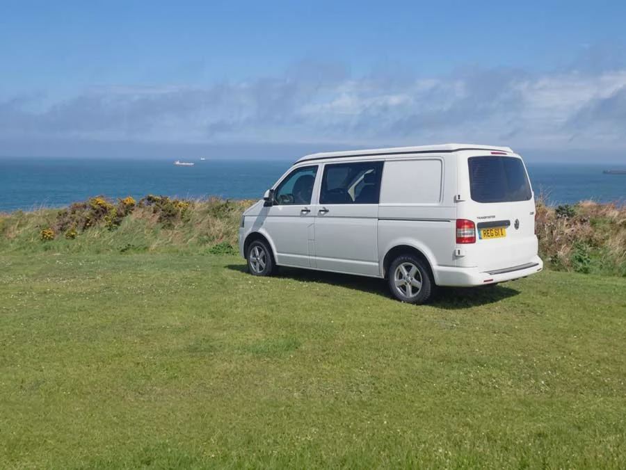 Campervan on the clifftop grass