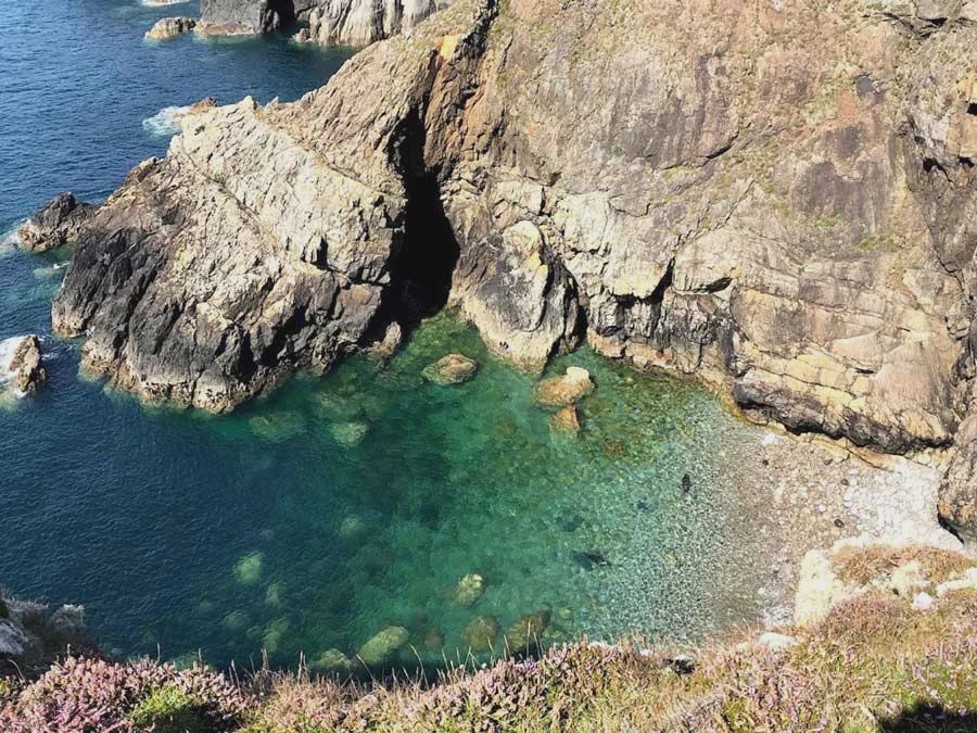 Rocky cove below the coast path
