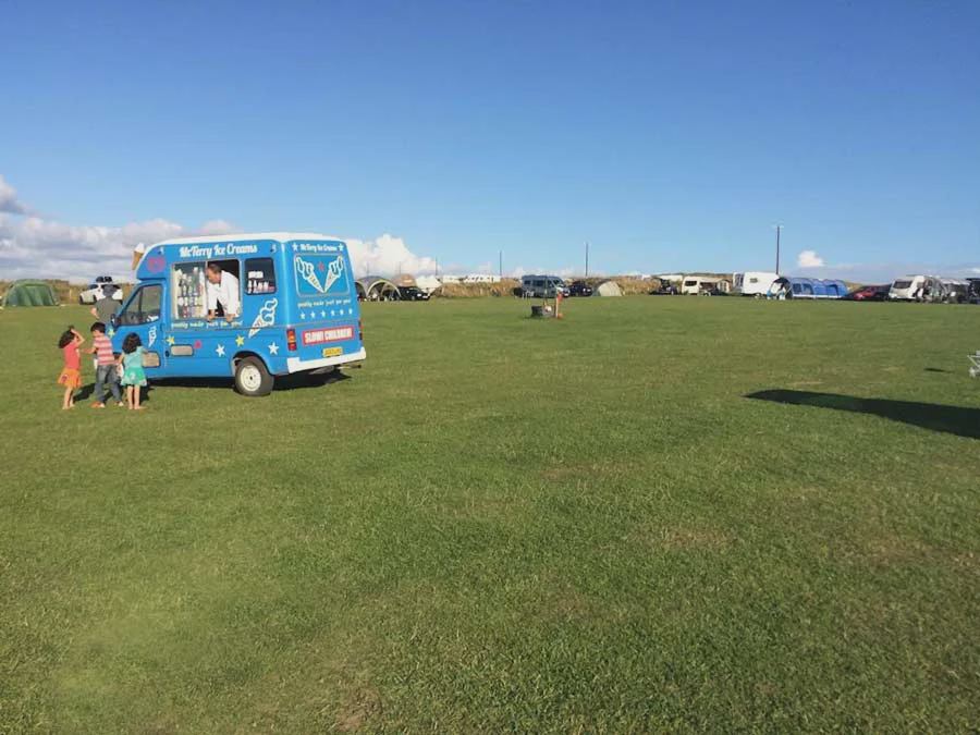 Grass field with the sea beyond