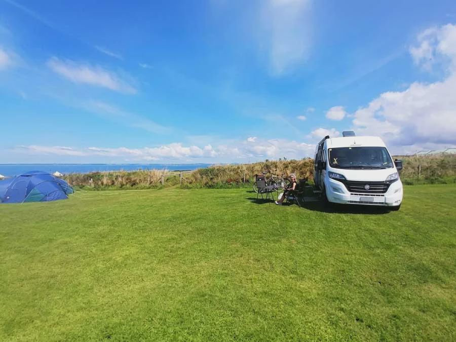 Camper and tent by the sea