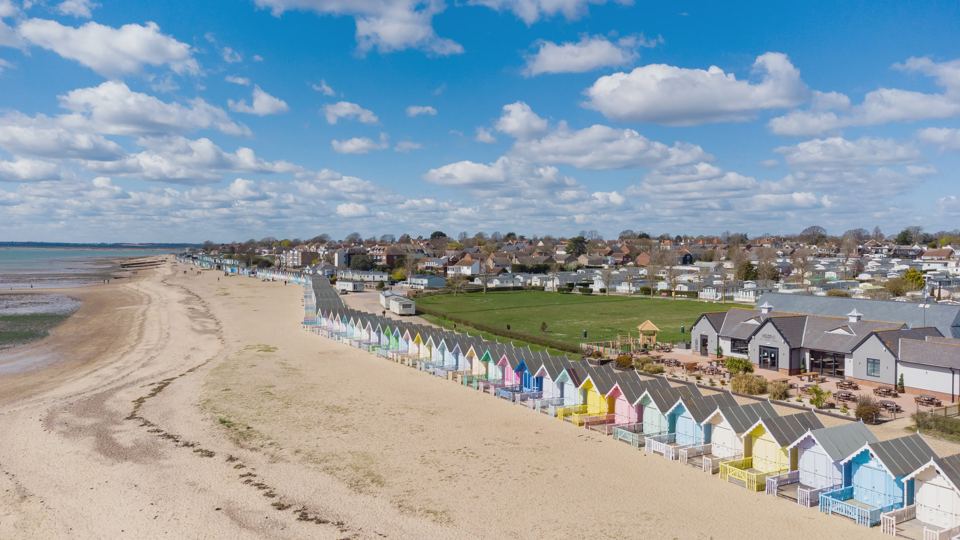 Beach huts and park along the shore