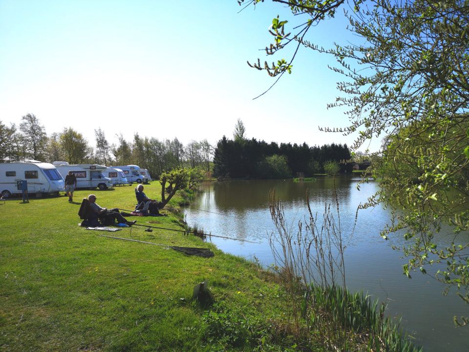 Caravans and anglers by the water