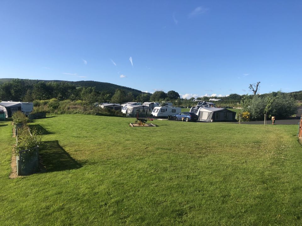 Lawn and pitches with hills beyond