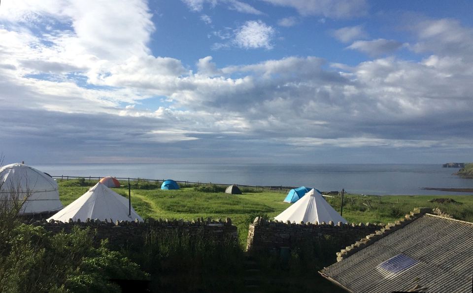 Tents and yurt above the sea