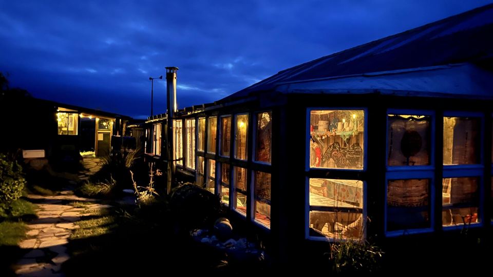 Conservatory lit up at dusk