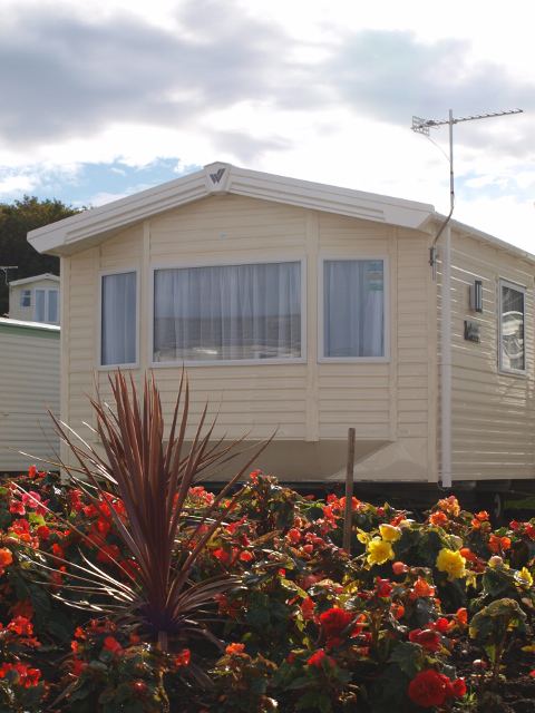 Caravan with flower bed