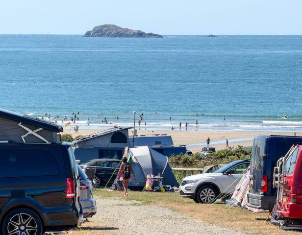 Campervans and tents by the beach