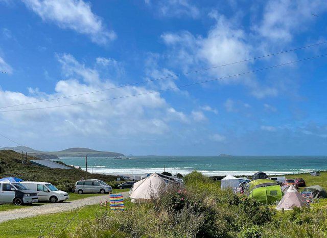 Tents and campervans overlooking the sea