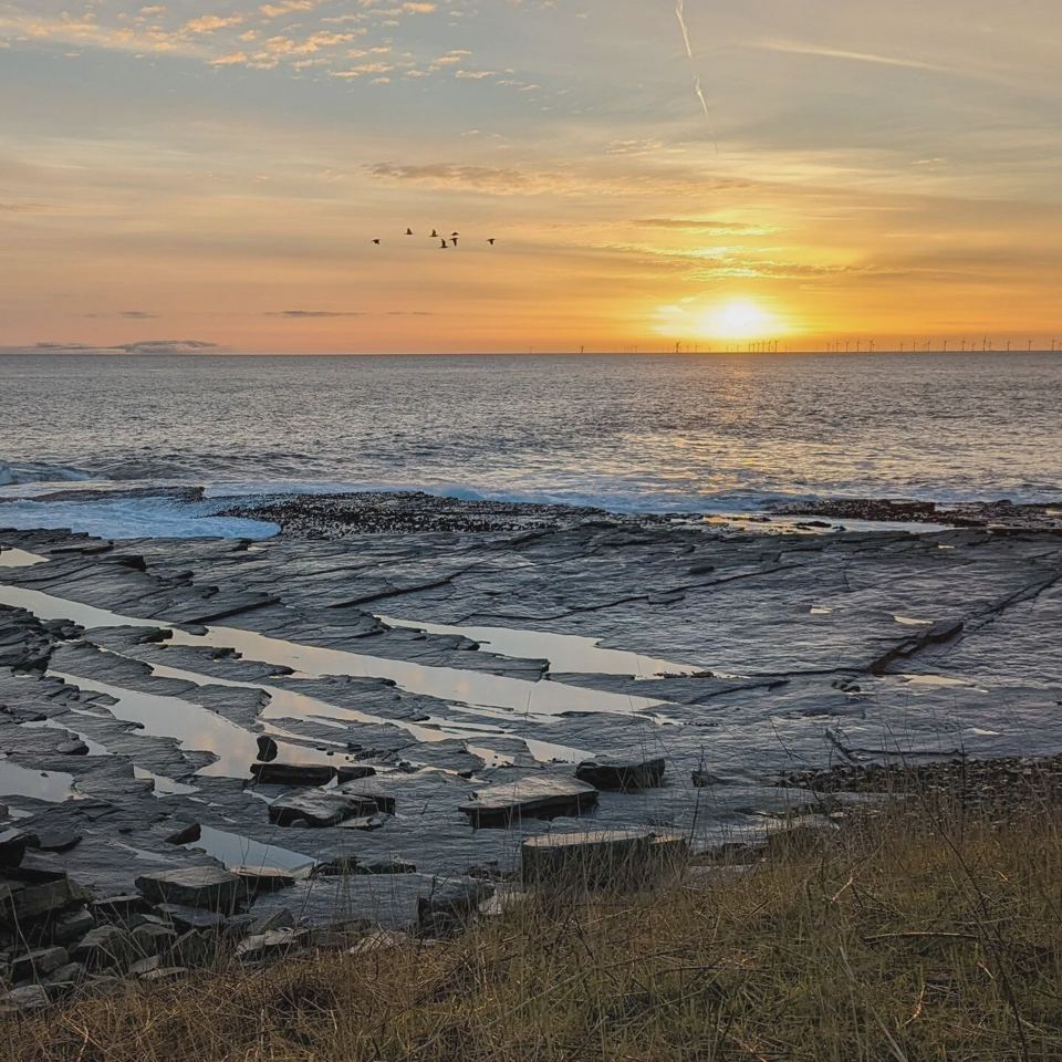 Sunrise over the rocky shore