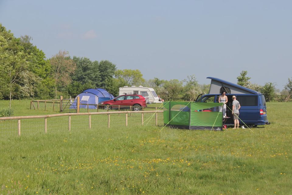 Campervan and tents on grass