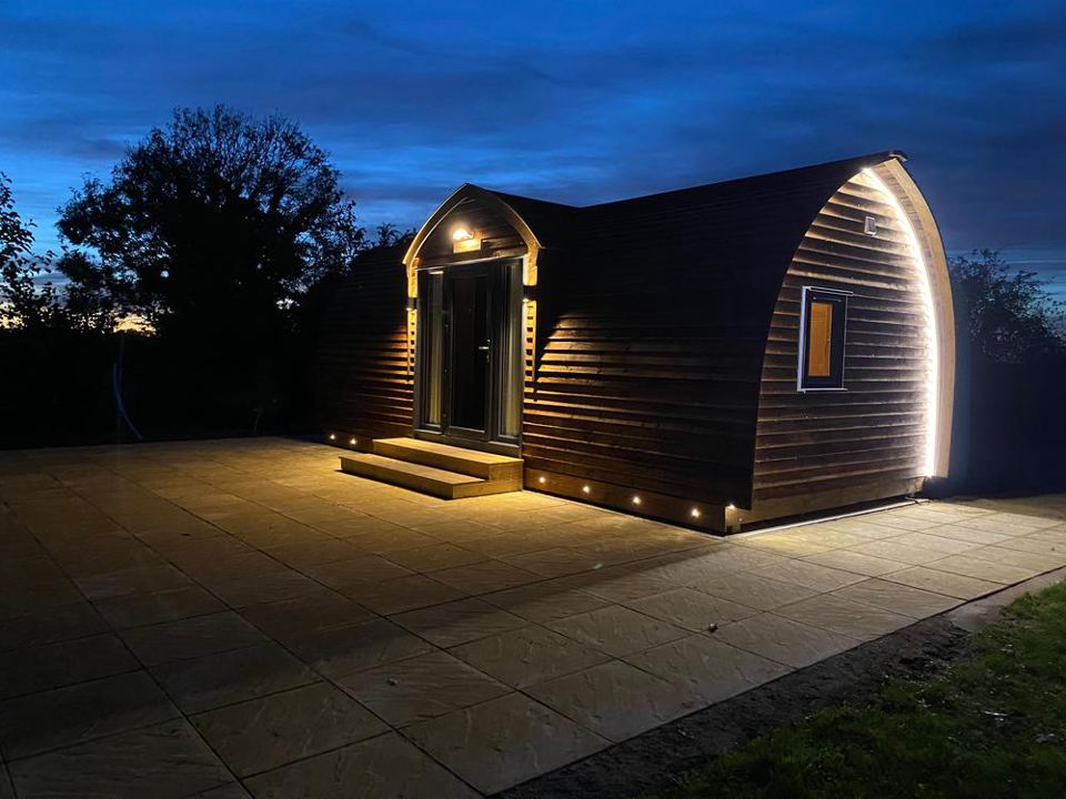 Wigwam cabin lit at dusk