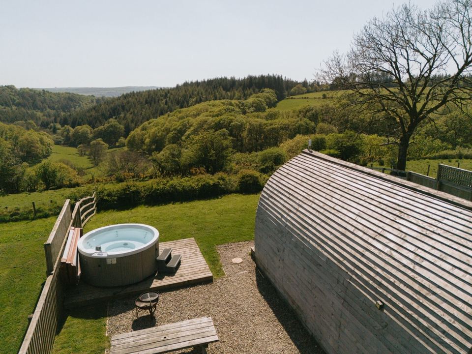 Hot tub on the decking with hills