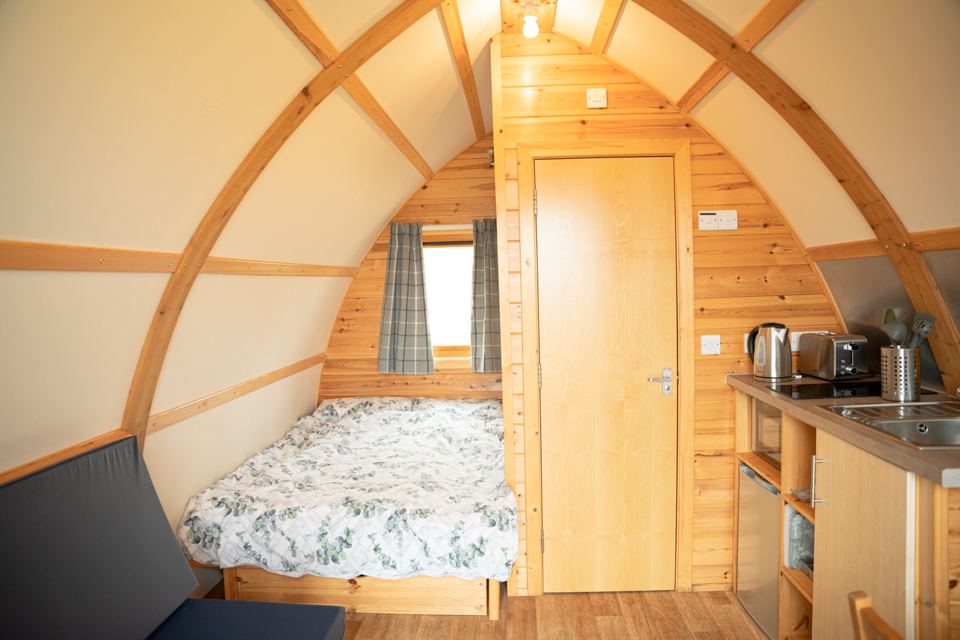 Bed and kitchenette inside a cabin