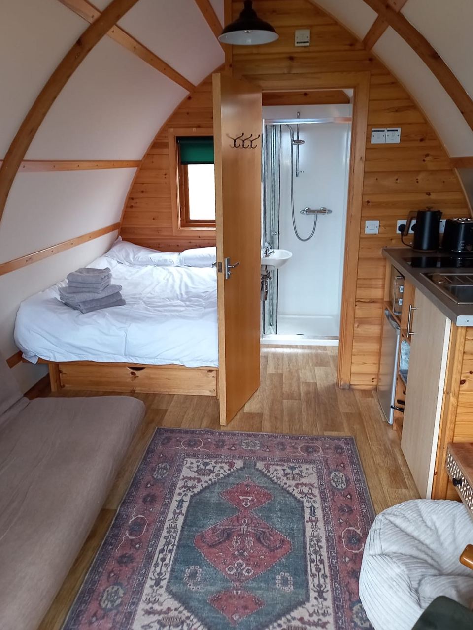 Bed and shower room inside a cabin