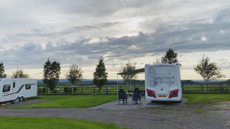 Motorhome and caravan on gravel pitches