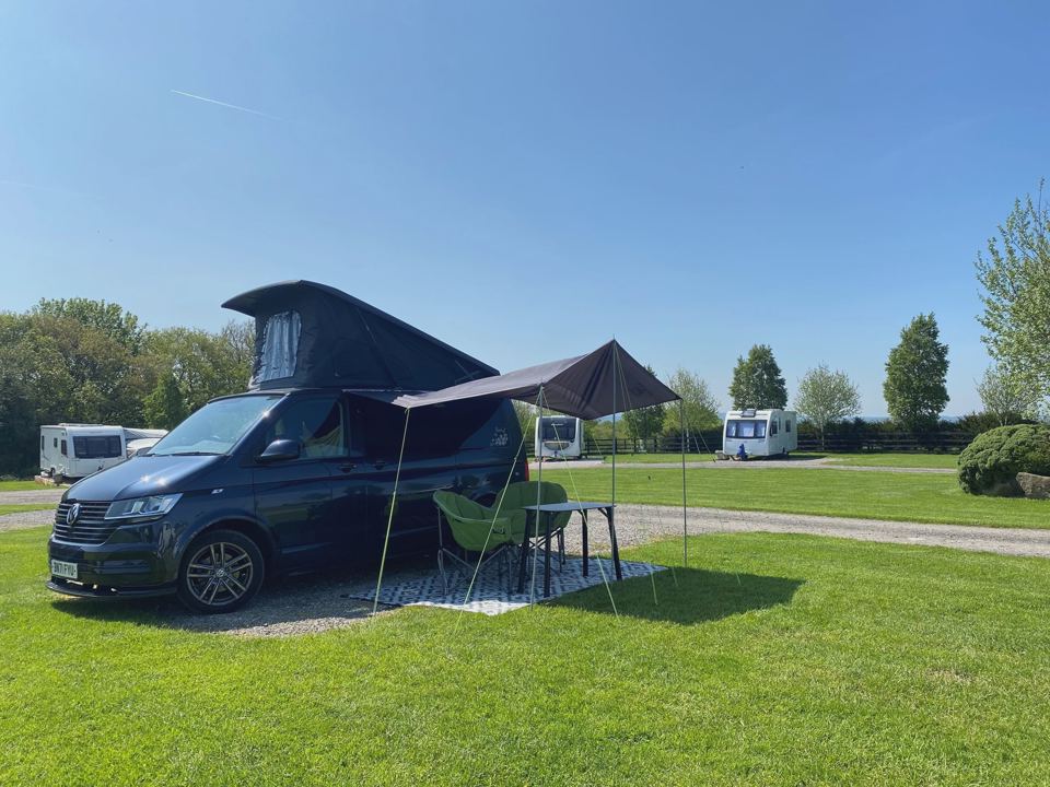 Campervan with awning on grass