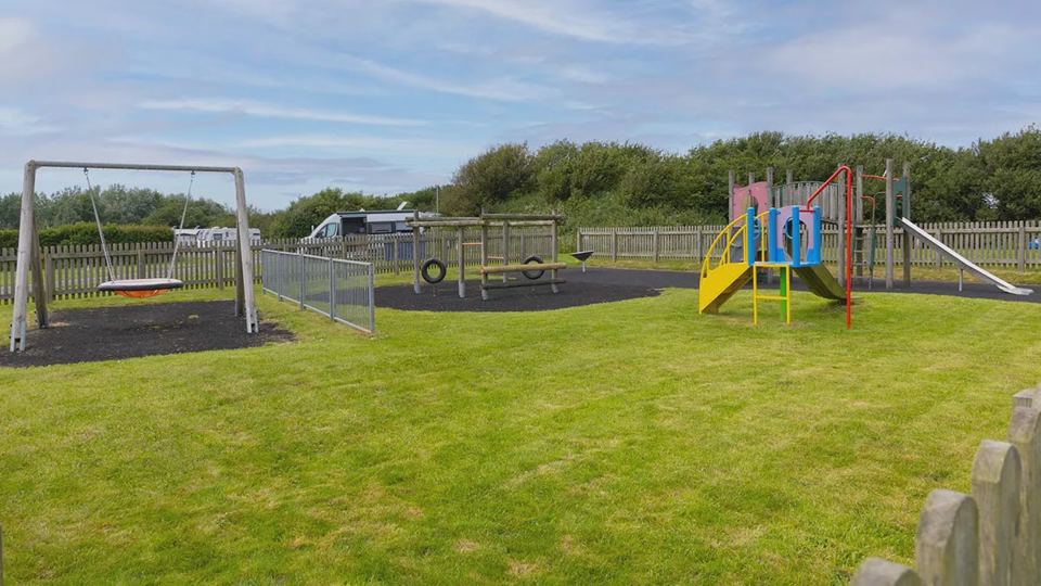 Play area with swings and slide