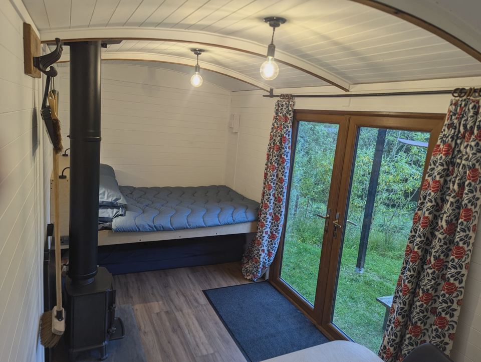 Hut bed beside the glazed doors