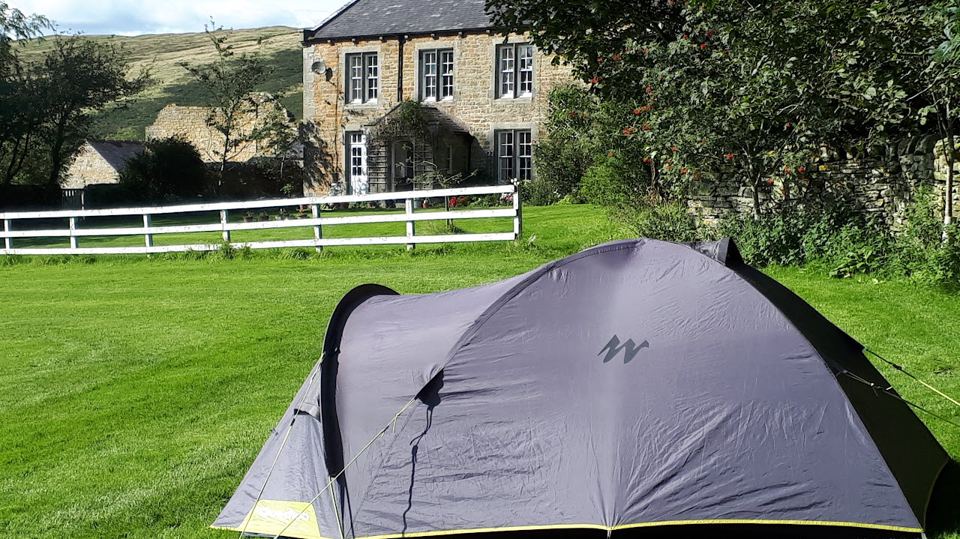 Tent below the farmhouse