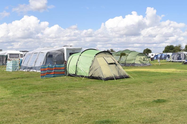 Tents and tourers on grass