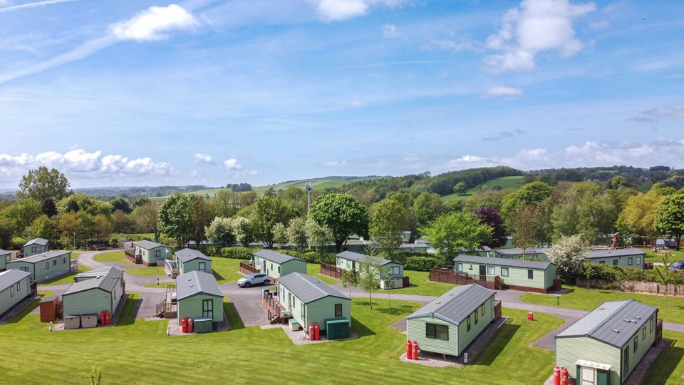 Lodges on the grass with hills