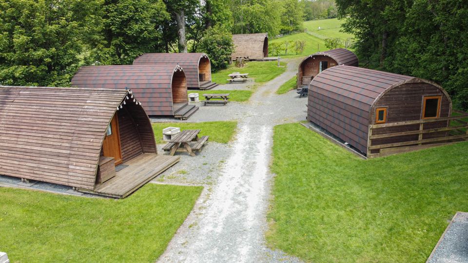Pods on the grass with picnic tables