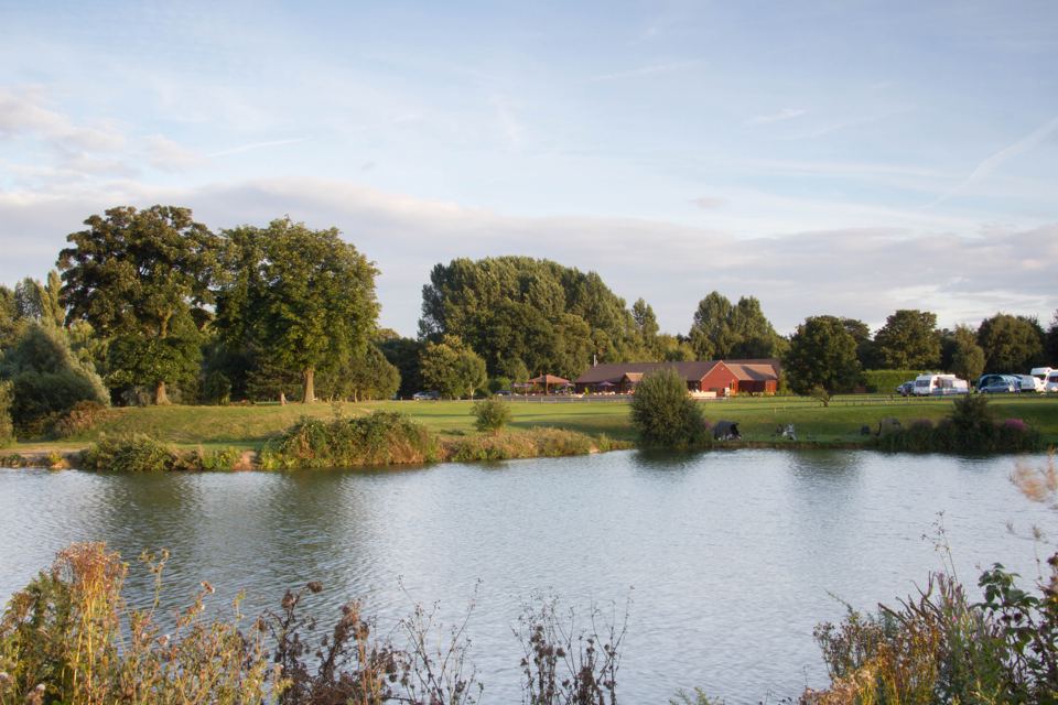 Lake with touring field beyond