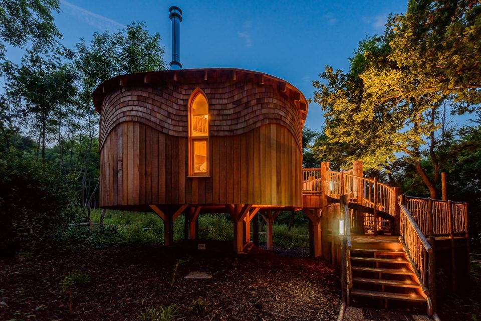 Treehouse lit up at dusk