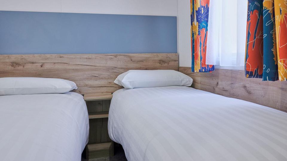 Twin bedroom with blue headboard