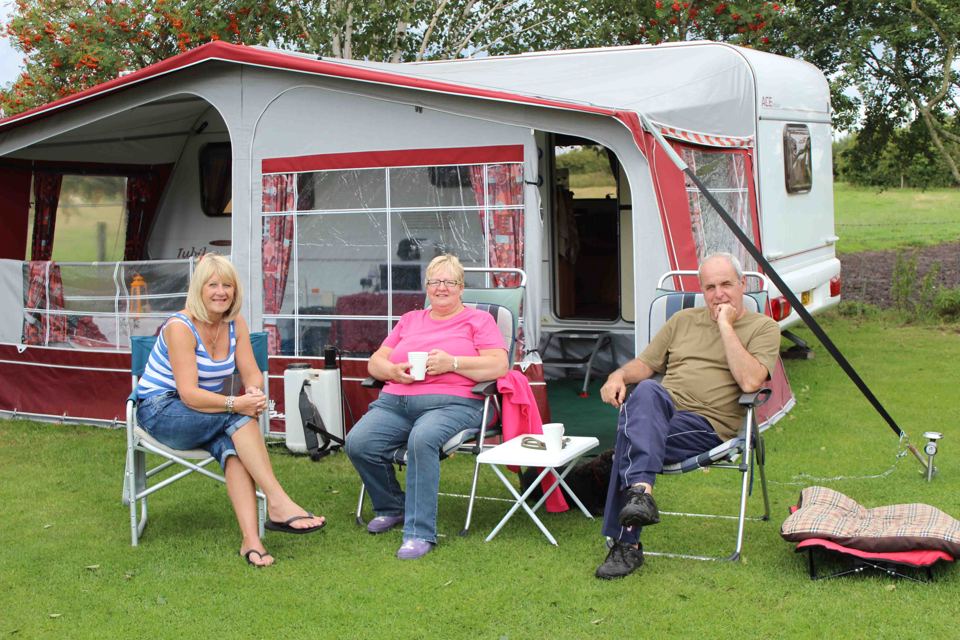 Caravan with awning on grass